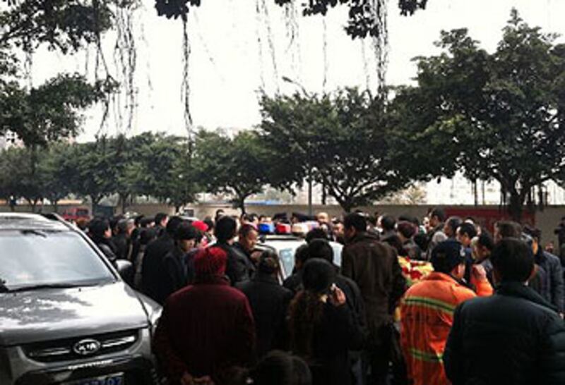 2013年2月8日，成都市高新區新北小區，一名自稱是公安領導親屬的女乘客與出租車司機發生糾紛，數百途人不滿所為，圍堵警車。 （網民提供） 