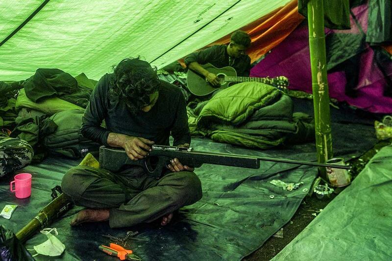 When not training, members perform maintenance on their homemade rifles. (AFP)