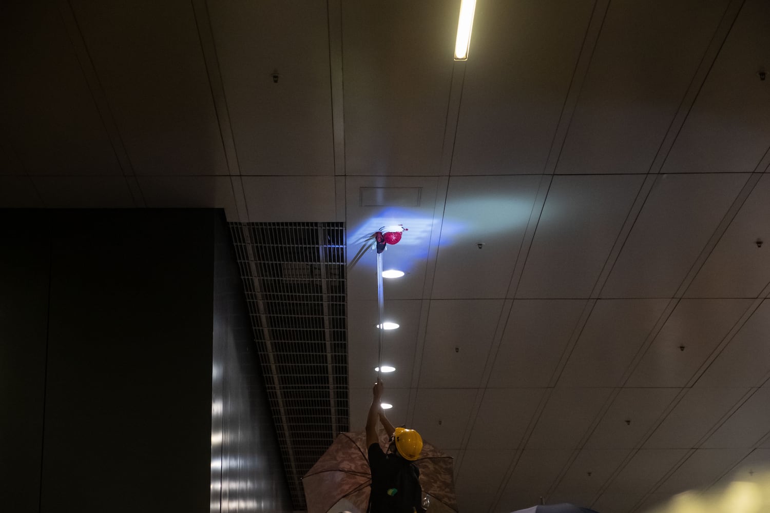 A protester covers surveillance cameras with paint on July 1, 2019 in Hong Kong.