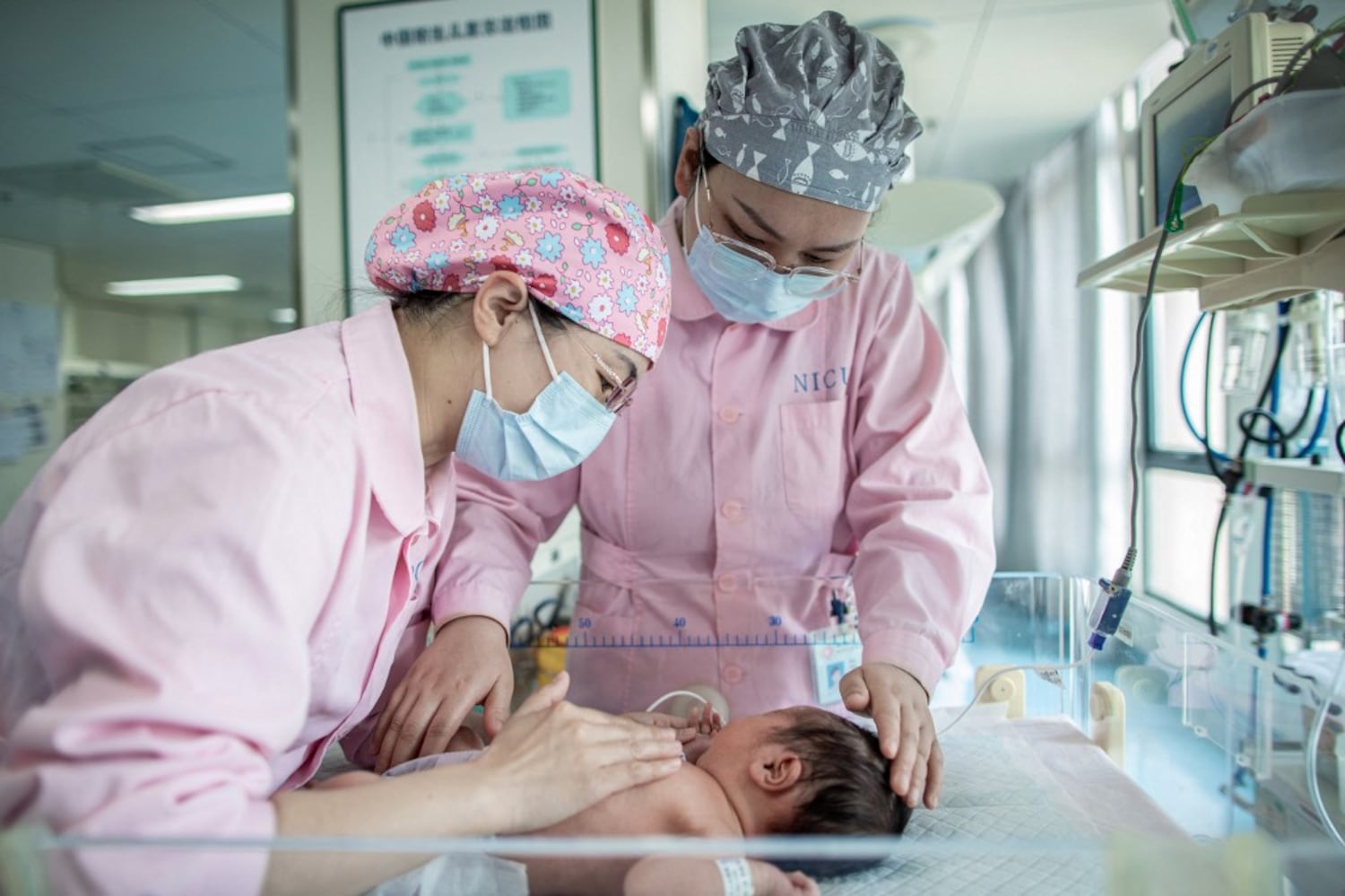 Nurses take care of a newborn baby at a hospital in Xinghua in China's eastern Jiangsu province, May 10, 2024.