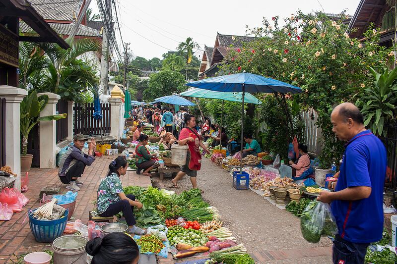 People shop at the fresh market in Luang Prabang, a UNESCO world heritage city in Laos, September 2023.