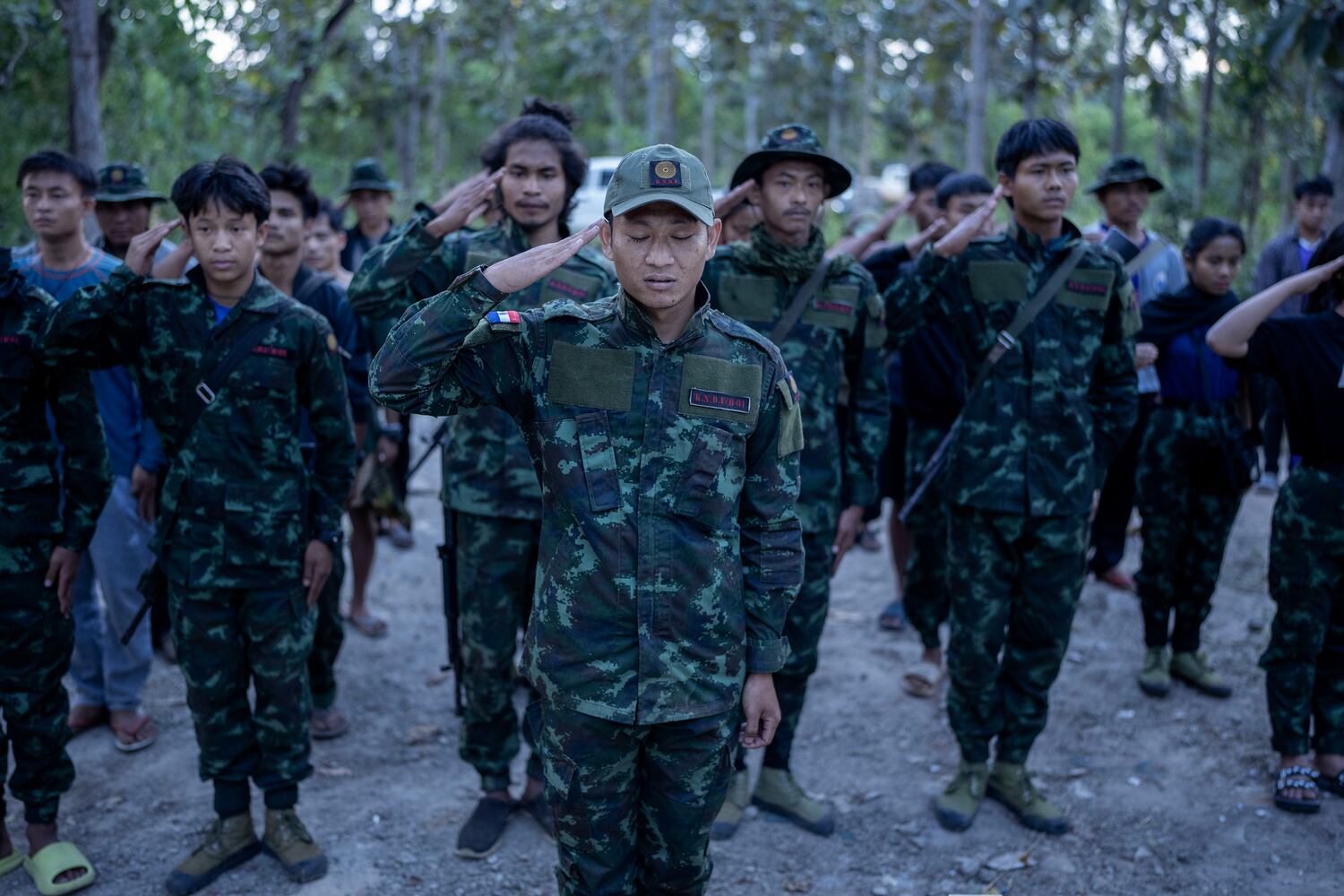 Karenni Nationalities Defense Force fighters salute at a grave of a few fighter at a martyrs cemetery to commemorate the fighters who died fighting Myanmar military in Demoso, Kayah state, Nov. 2, 2024. (RFA)