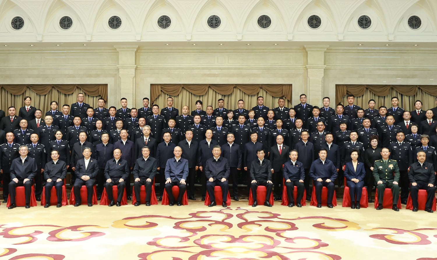 In this Chinese government image that could not be independently verified, President Xi Jinping, seated center, poses for a group photo while meeting with representatives of judicial workers and police officers in Urumqi, Xinjiang Uyghur Autonomous Region, Sept. 23, 2025. (Ding Lin/Xinhua via Getty Images)