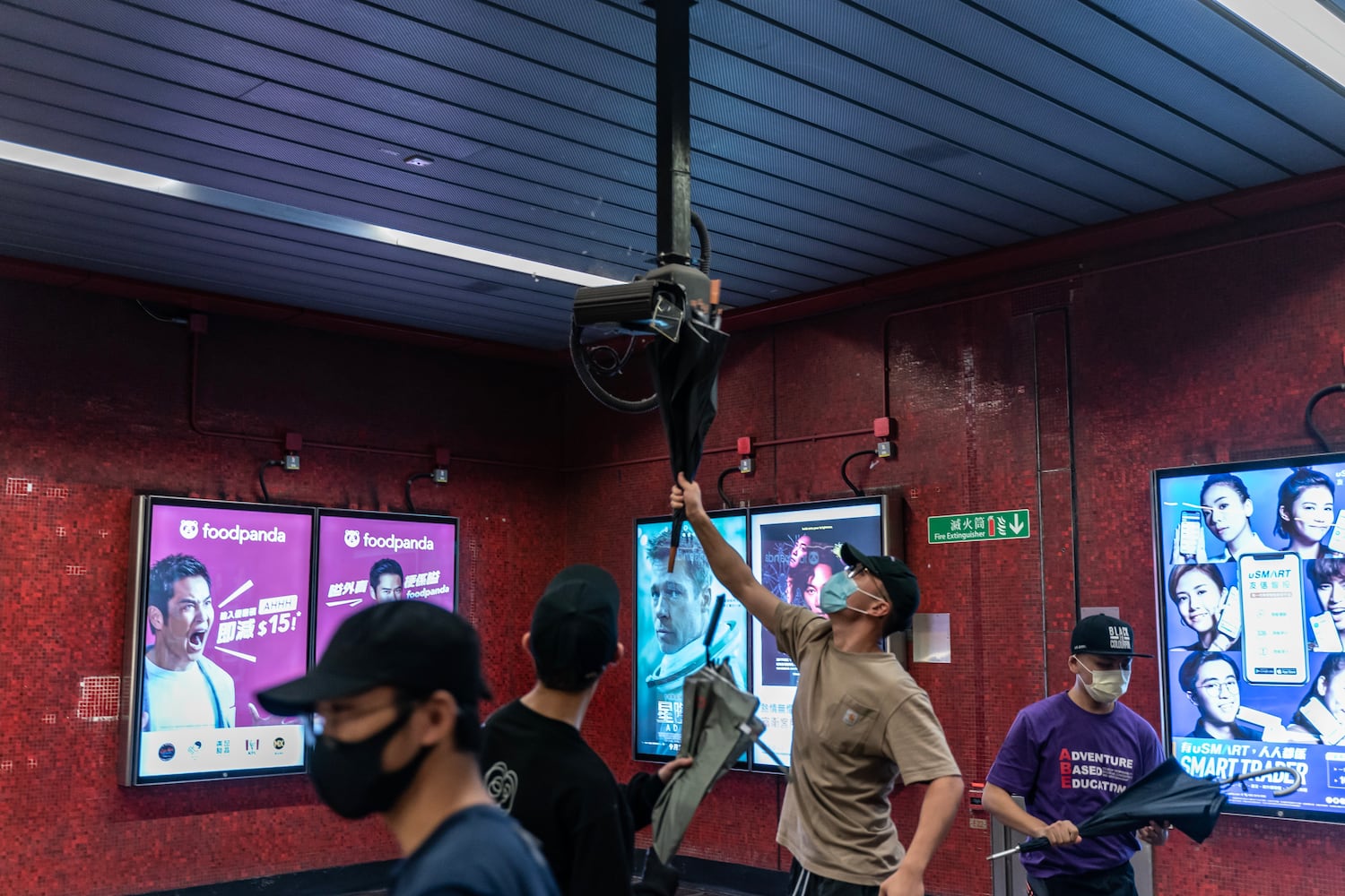 Pro-democracy protesters break a surveillance camera at a Tai Koo MTR station on October 3, 2019 in Hong Kong.