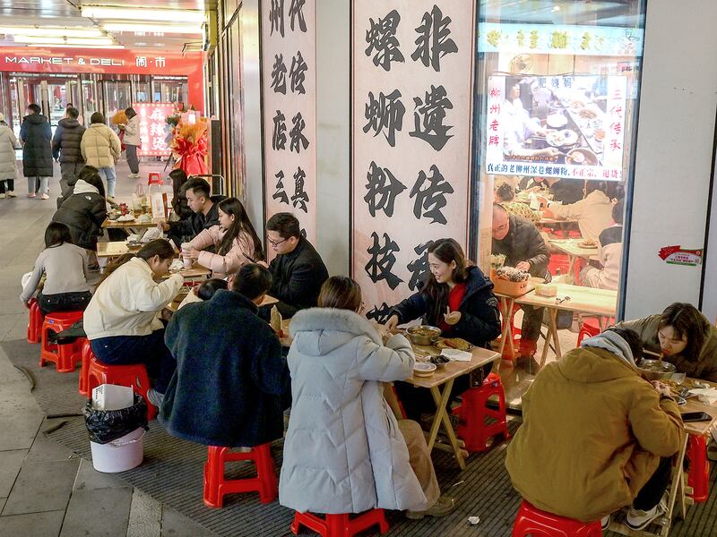 People dine outside a restaurant in Beijing on Jan. 18, 2025.