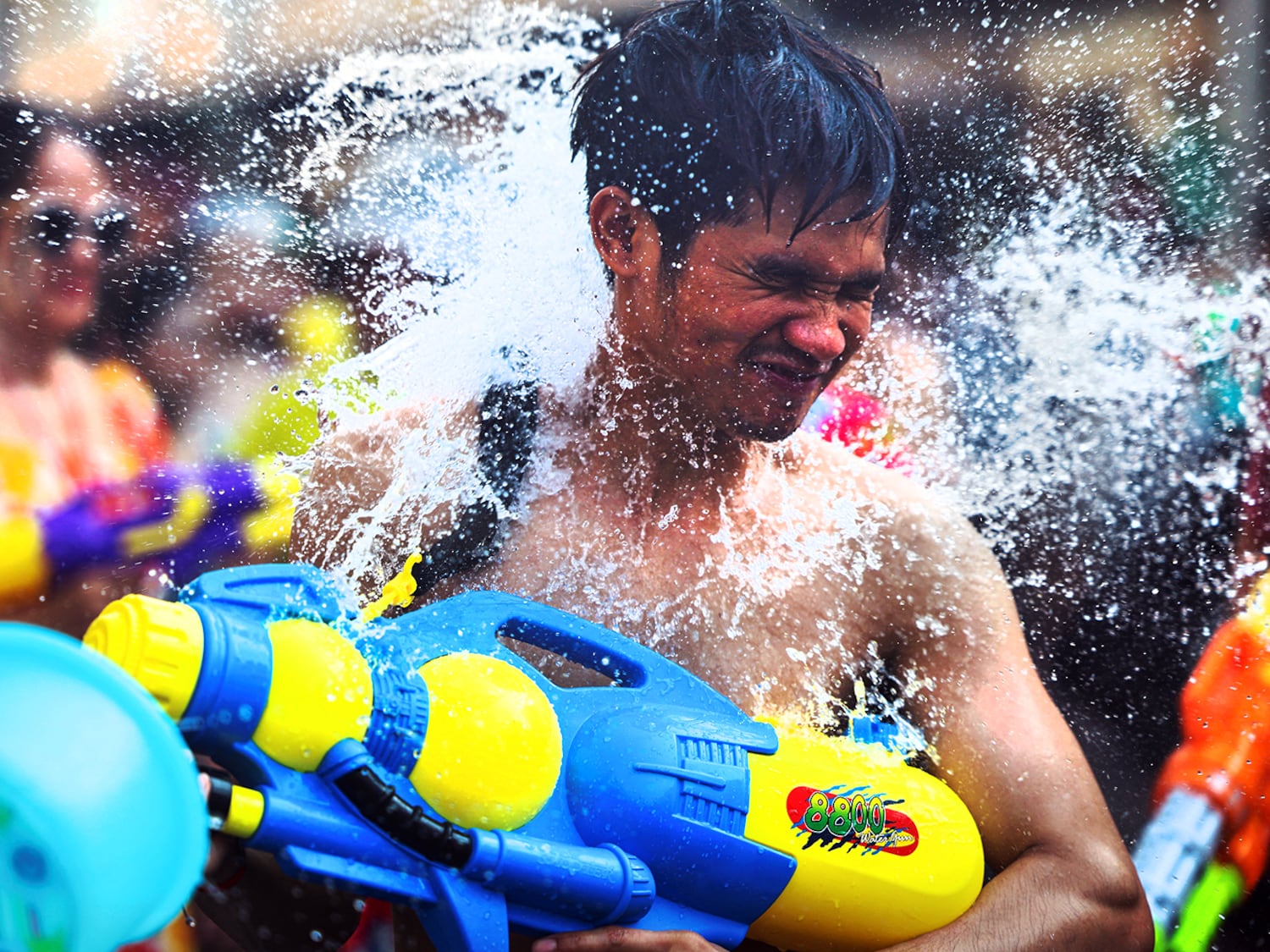 A reveler plays with water as he celebrates the Songkran holiday, which marks the Thai New Year in Bangkok, Thailand, April 14, 2024.