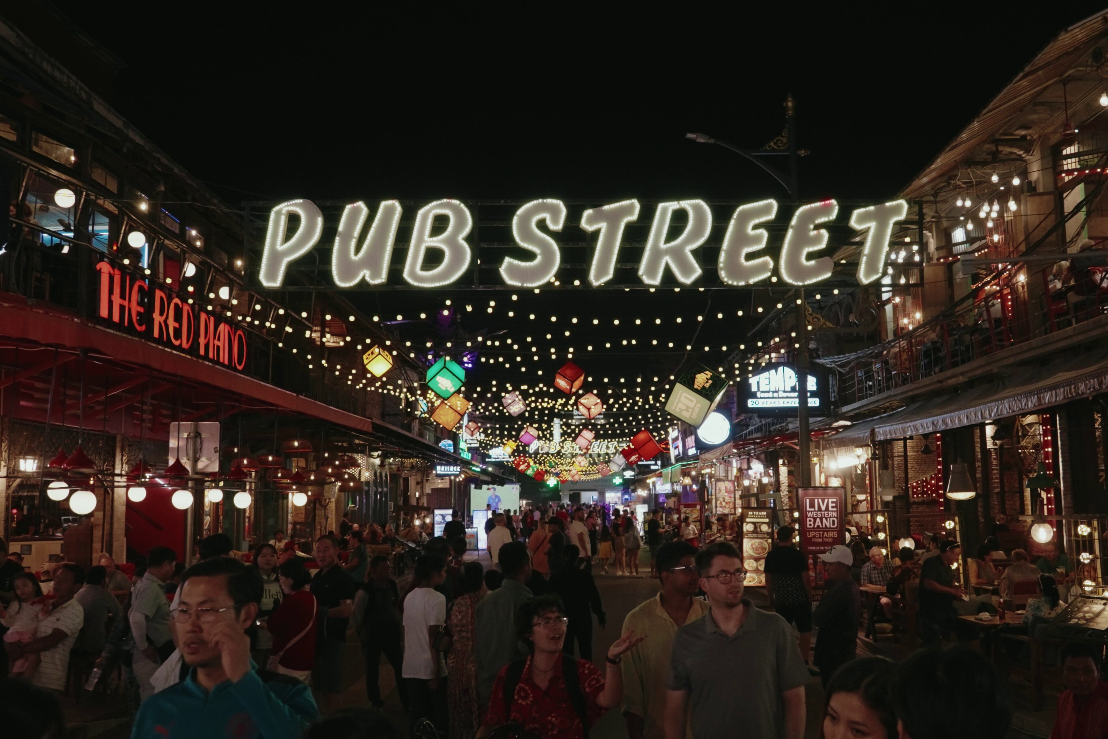 Cambodians and foreigners enjoy walking in busy night life center in Pub Street and Old Market in Siem Reap province, Cambodia.
