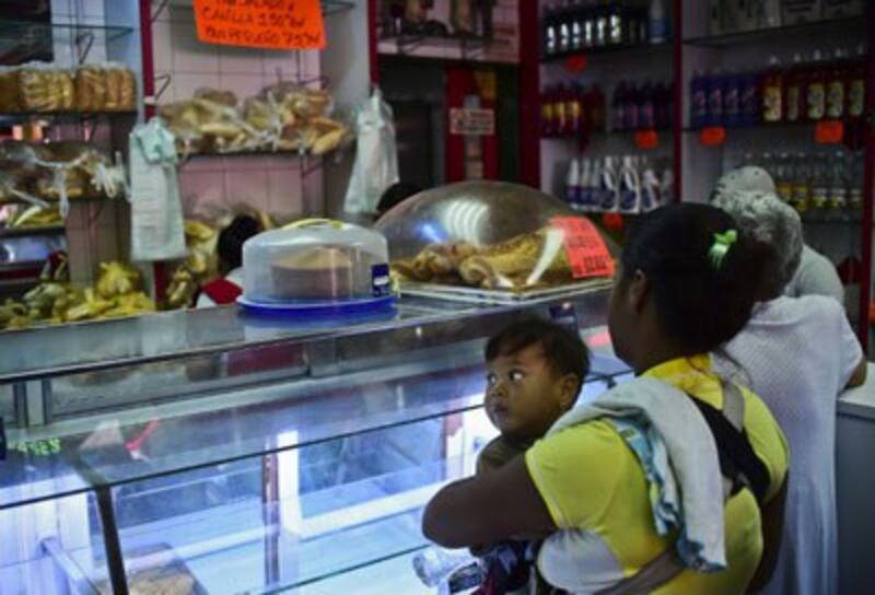 Người dân mua bánh mì ở một tiệm bánh ở Caracas, ngày 14 Tháng Chín năm 2016. AFP photo