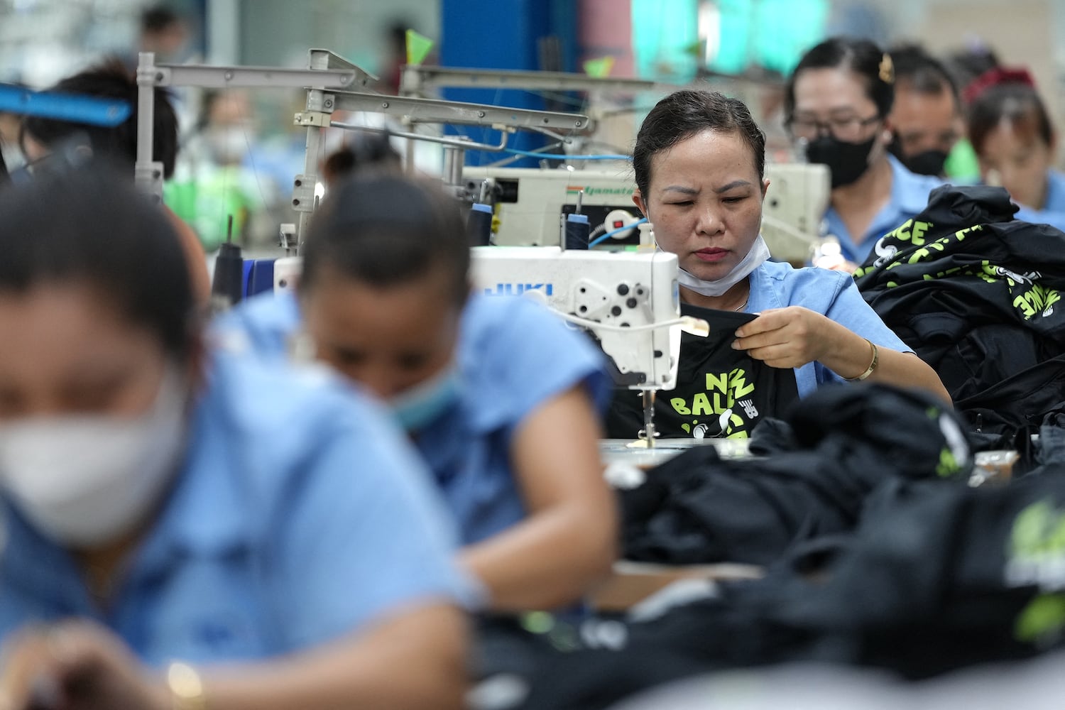Vietnamese garment factory workers stitch apparel at a factory in Ho Chi Minh City on April 3, 2025.