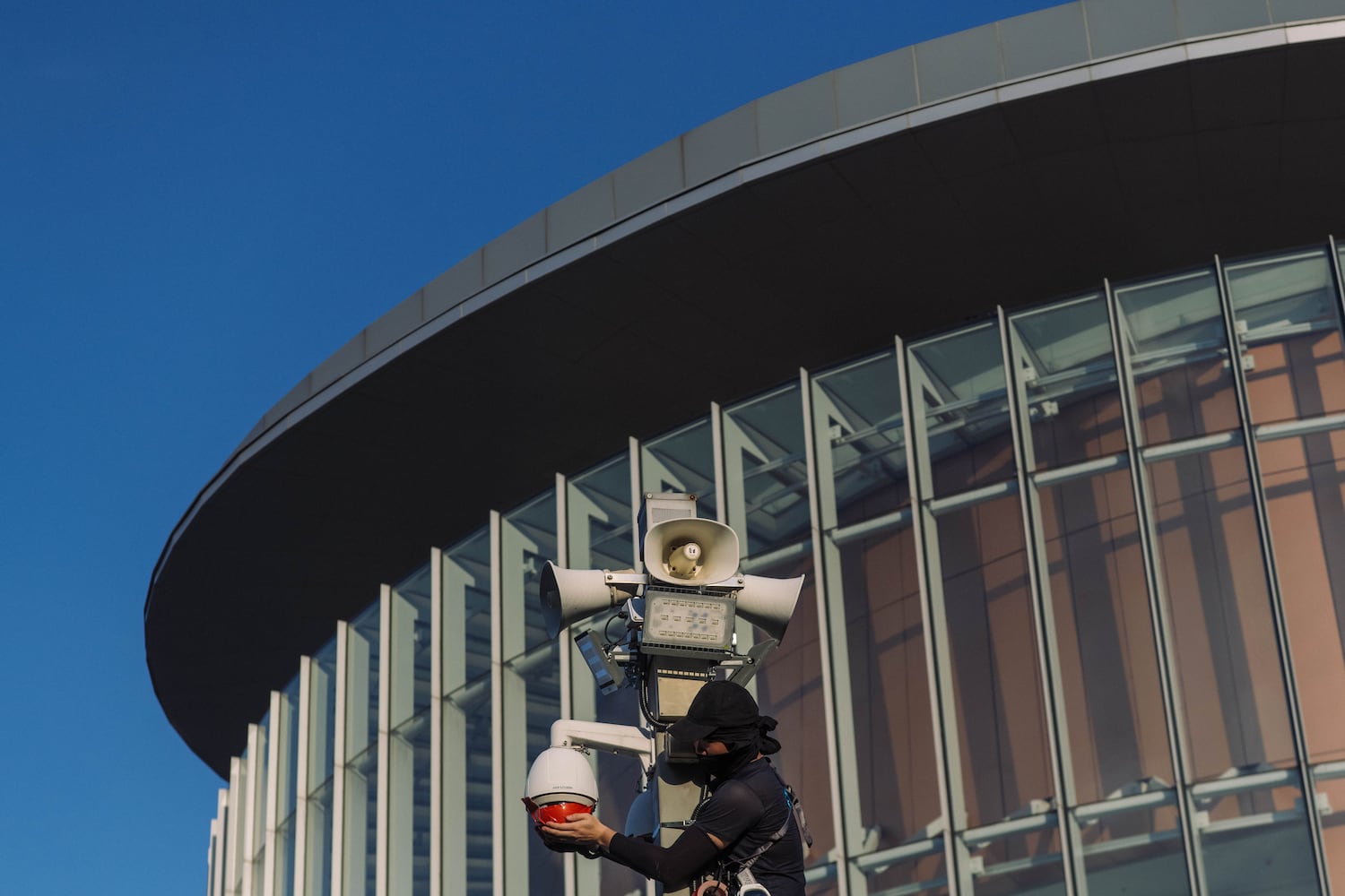 A protester covers surveillance cameras during anti-extradition bill march in Hong Kong on July 21, 2019.