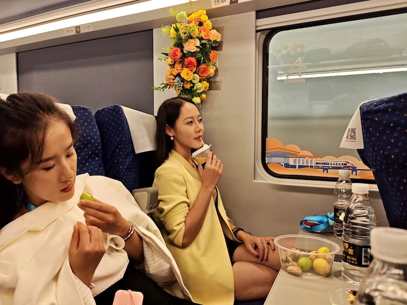This image released by Chinese government media shows Chinese tourists on a train of the China-Laos Railway on Sept. 20, 2025.