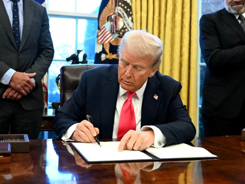 President Donald Trump signs an executive order in the Oval Office of the White House, Feb. 25, 2025.