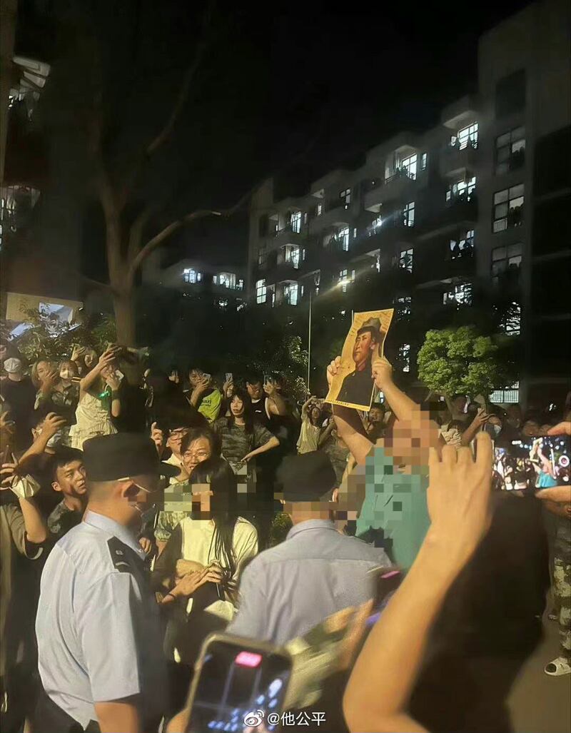 有人手持毛澤東畫像，有校方保安在旁戒備。（網絡圖片）