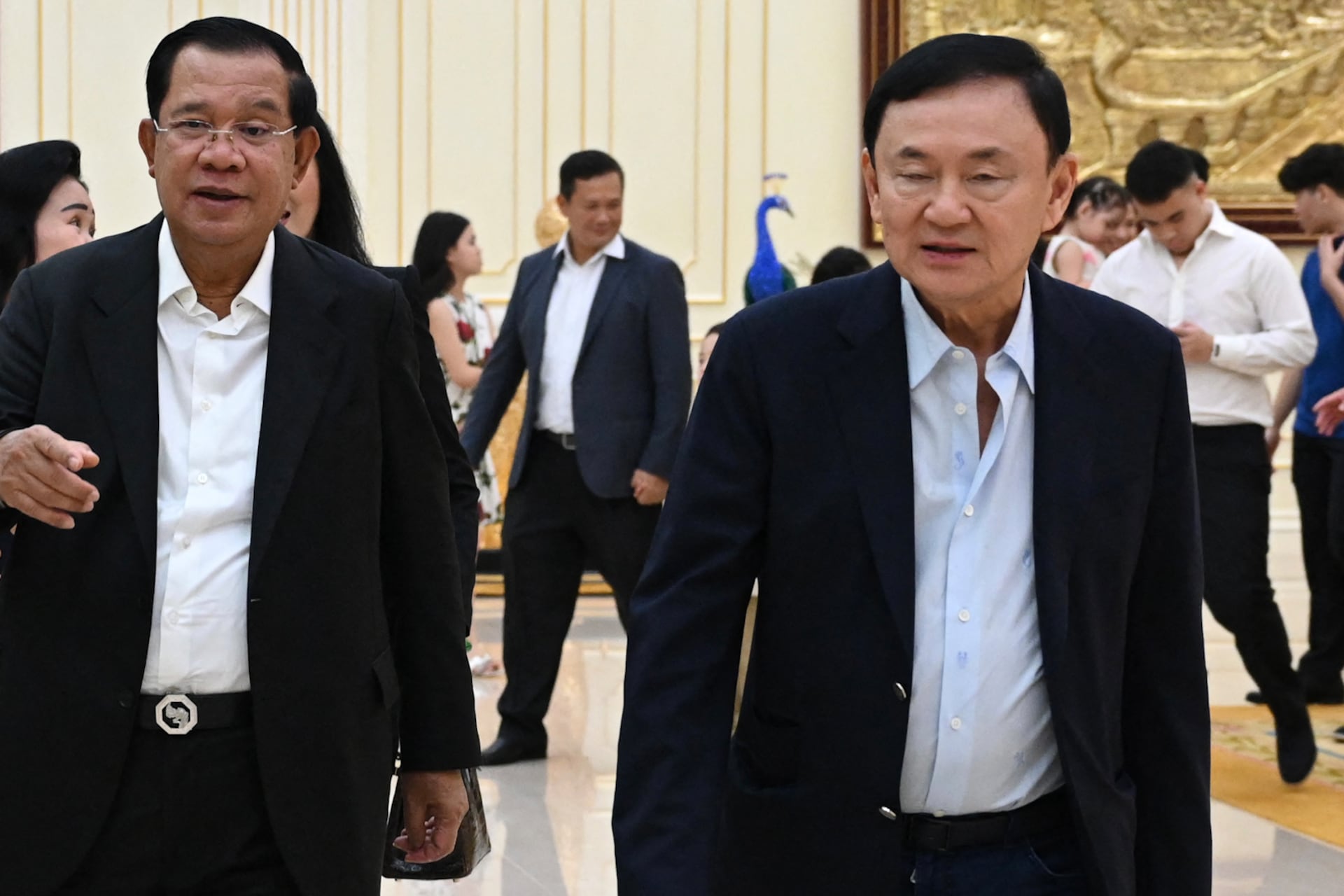 Thailand’s former prime minister Thaksin Shinawatra (R) walking with Cambodia’s Prime Minister Hun Sen (L) during the latter's birthday in Phnom Penh.