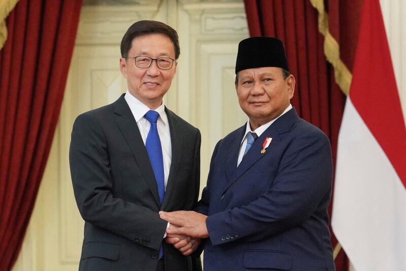 Indonesia's newly sworn-in President Prabowo Subianto (R) greets China's Vice President Han Zheng during their meeting at Merdeka Palace in Jakarta on October 20, 2024. (Photo by Achmad IBRAHIM / POOL / AFP)