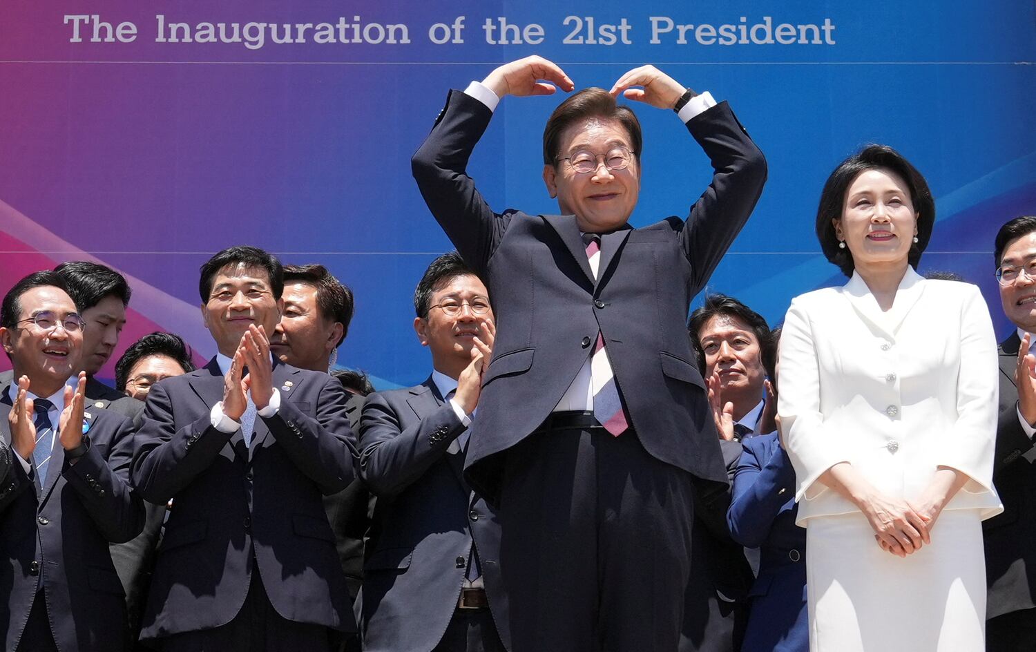 South Korea's new President Lee Jae-myung, and his wife Kim Hye-kyung, greet people after attending the Presidential Inauguration at the National Assembly in Seoul, June 4, 2025.