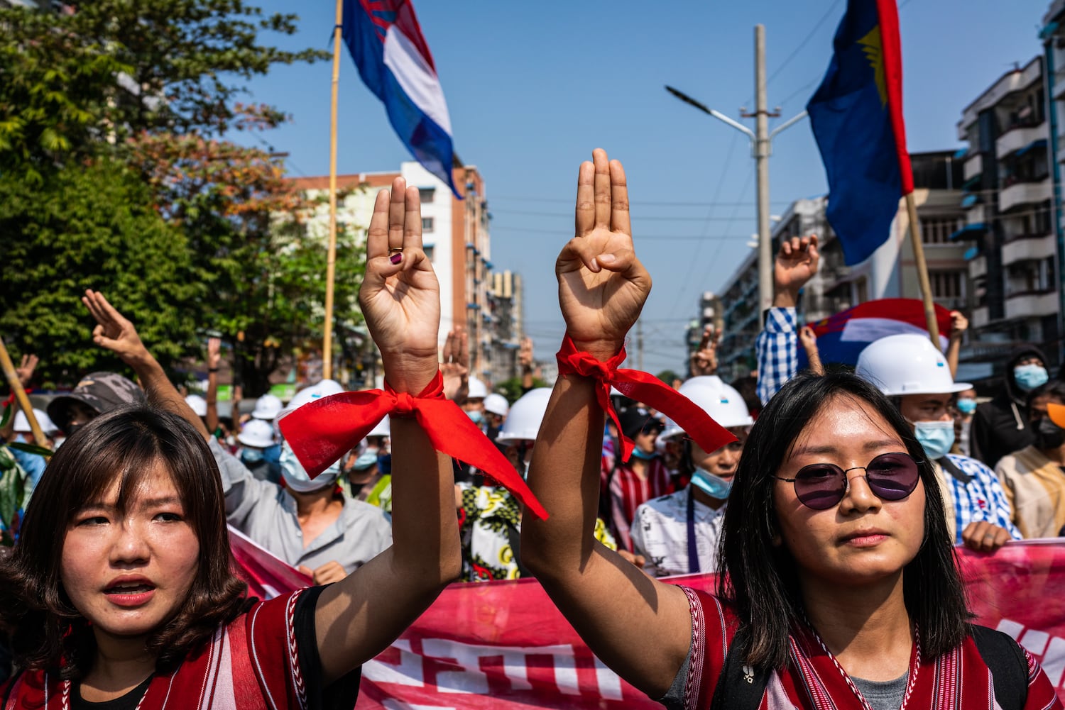 People make three-finger salutes during an anti-coup march on February 6, 2021 in Yangon, Myanmar.