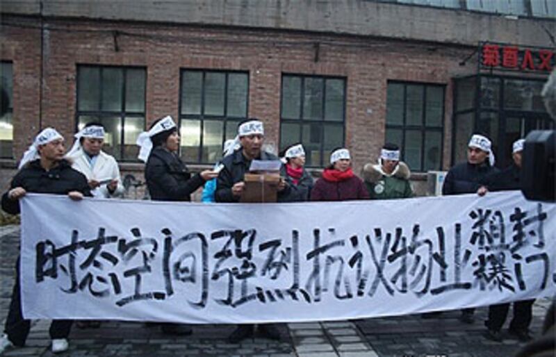 北京798藝術區始創人徐勇的工作室被封門,他率領約五十人在園區遊行抗議。(照片由現場人士提供)
