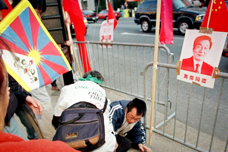 A Chinese student supporting Chinese Premier Zhu Rongji is knocked to the ground by protesters supporting Tibetan and Taiwanese independence, April 14, 1999 at MIT in Cambridge, Massachusetts.