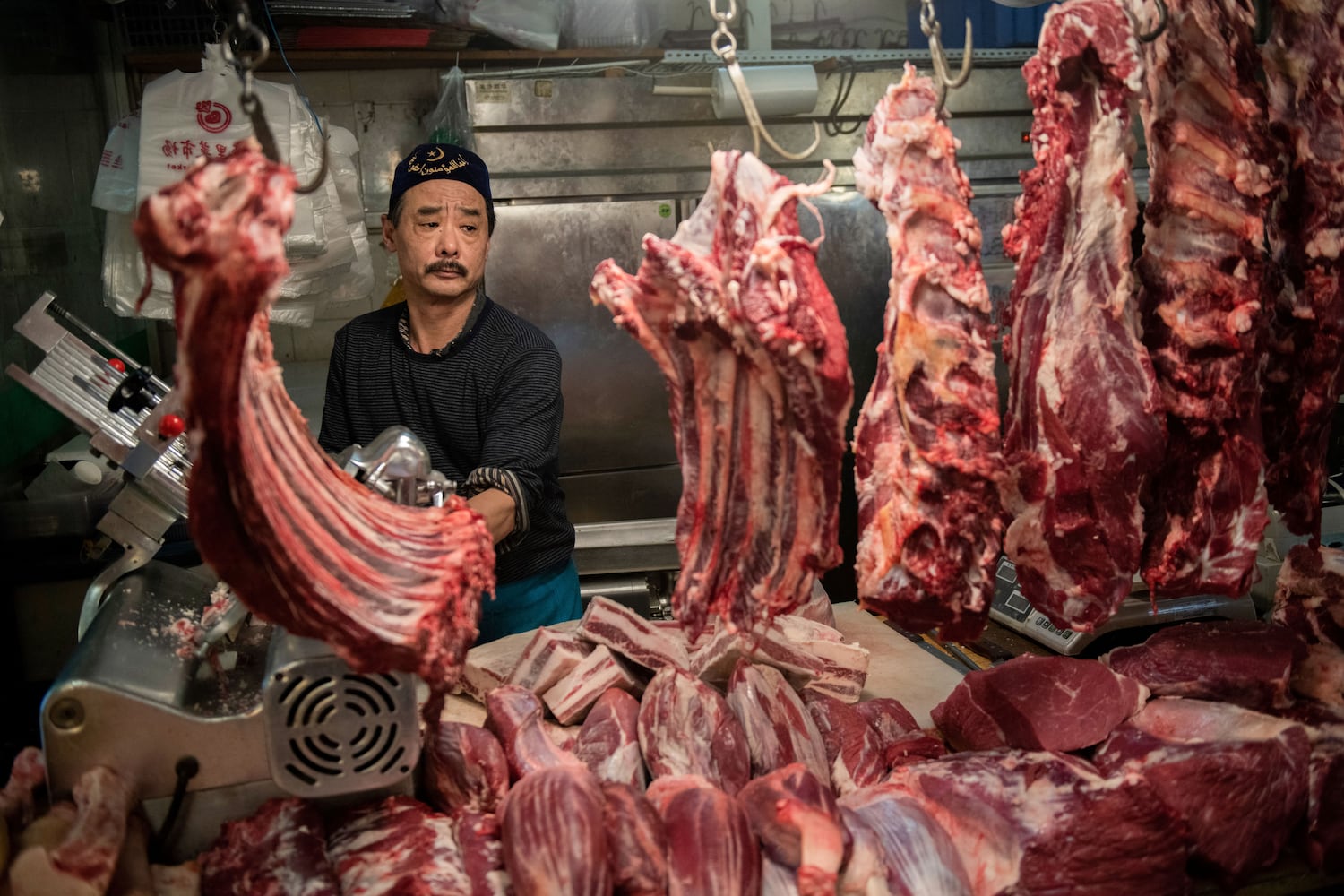 In this April 4, 2019, photo, a halal butcher cuts meat in his stall at a market in Beijing. (Nicolas Asfouri/AFP)