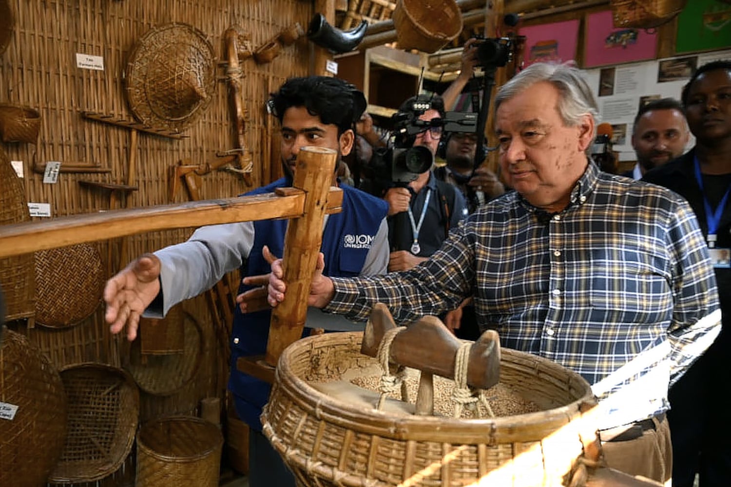 U.N. Secretary-General António Guterres observes a traditional tool used by Rohingya to thresh rice, March 14, 2025.