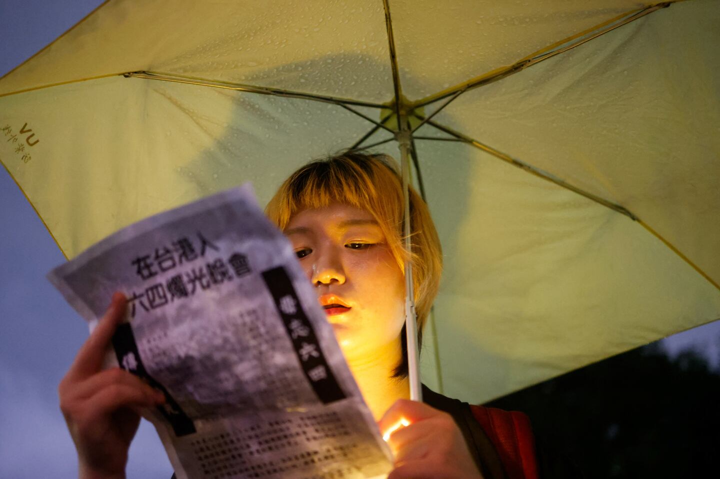 A woman holds a poster for a candlelight event to commemorate the 36th anniversary of the crackdown on pro-democracy demonstrators in Tiananmen Square on June 4, 1989, in Taipei, Taiwan June 4, 2025.
