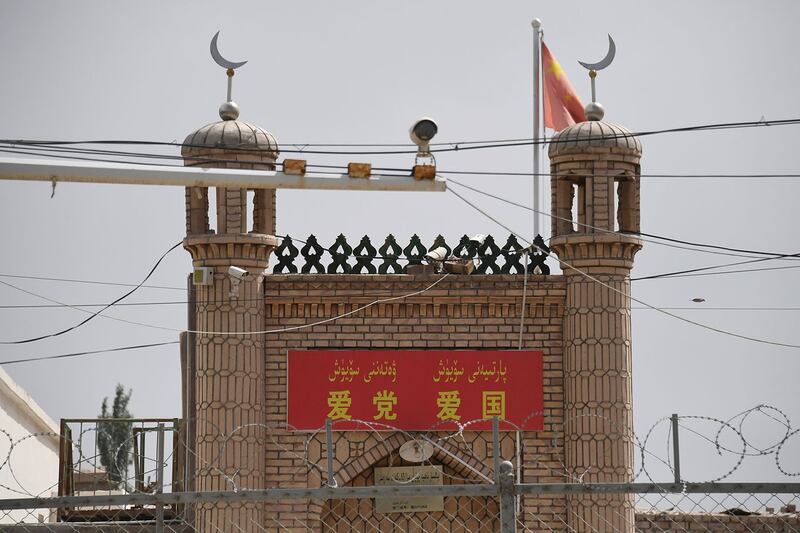 2019年6月4日，在新疆喀什市一座清真寺入口上面写着“爱党爱国”标语。（法新社）