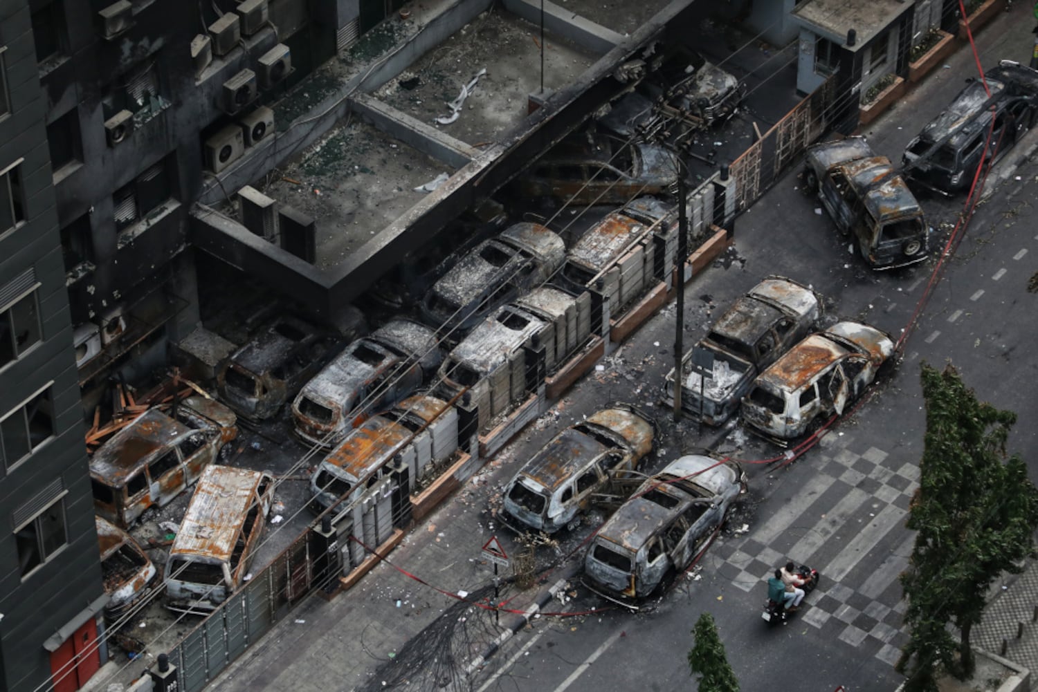 Vehicles burned in fires three days earlier remain on the street near the Disaster Management Directorate office in Dhaka, July 21, 2024. (Jibon Ahmed/BenarNews)