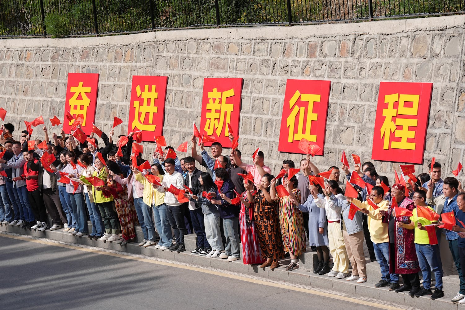 In this Chinese government image that could not be independently verified, President Xi Jinping, is greeted by people in Urumqi, Xinjiang Uyghur Autonomous Region, Sept. 23, 2025. (Wang Peng/Xinhua via Getty Images)
