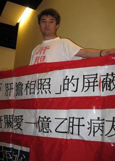 图片：肝胆相照论坛负责人陆军手举横幅在RFA接受本台采访（RFA)