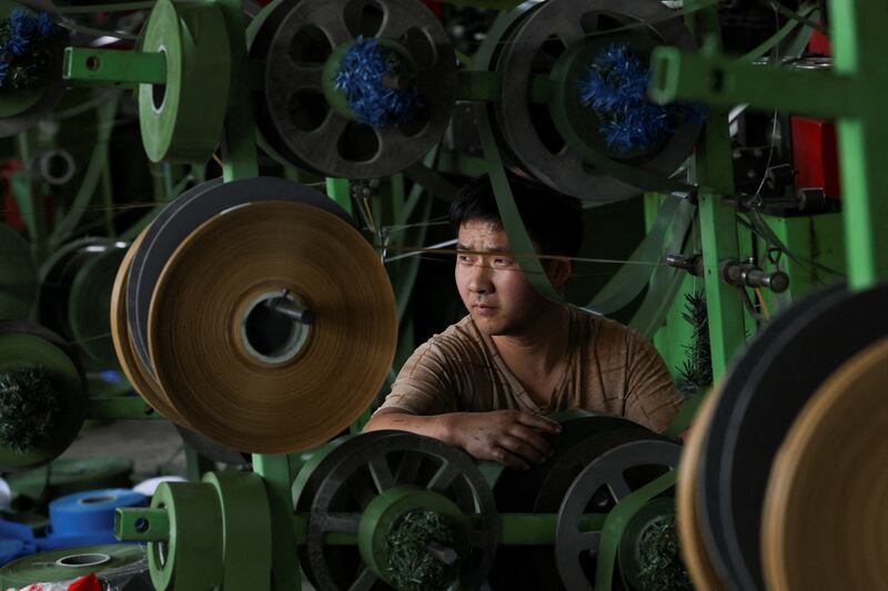 A worker at a factory that makes Christmas trees for export in Shaoxing, Zhejiang province, China, April 9, 2025.