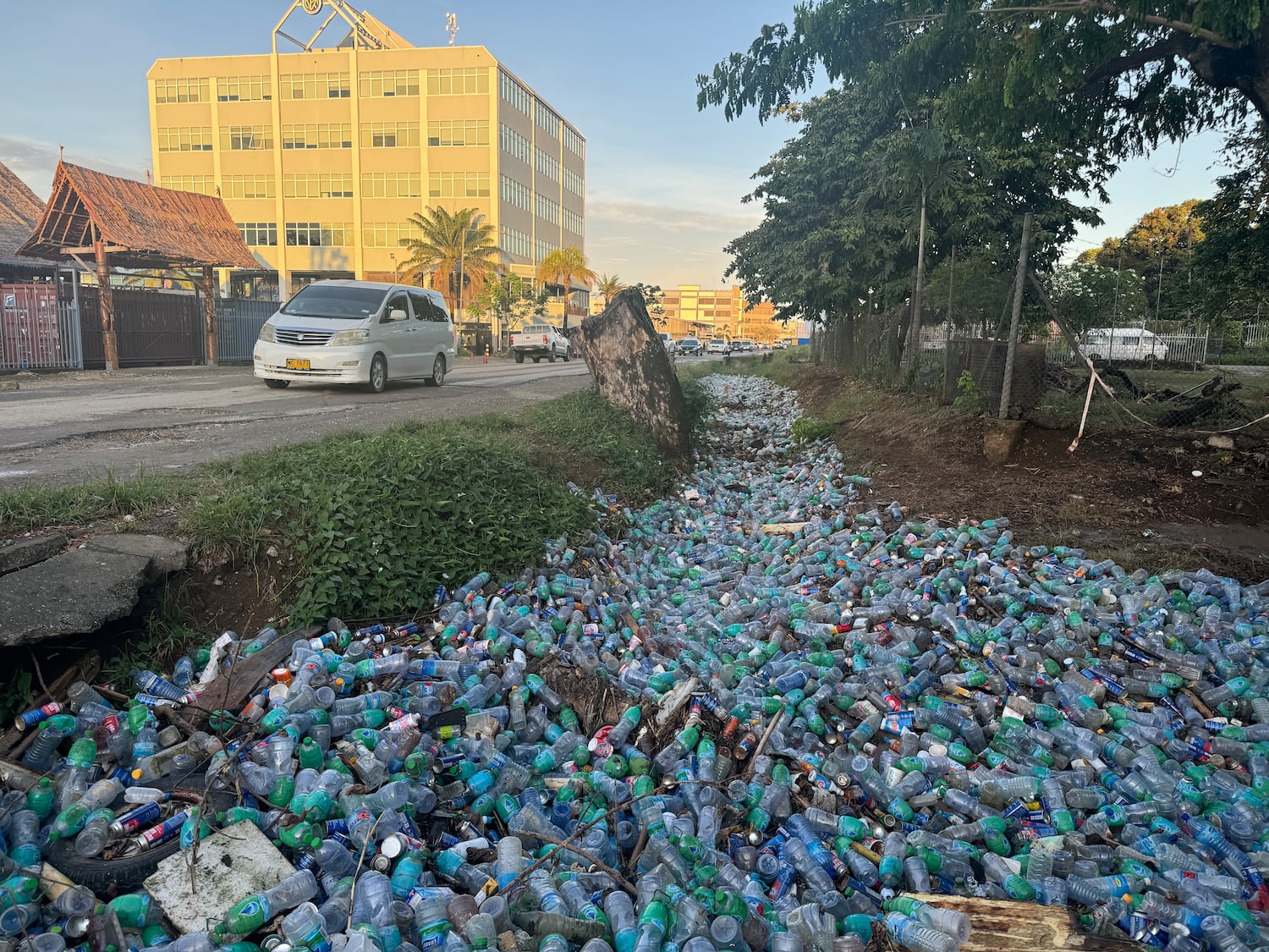 Discarded plastic bottles are pictured on Nov. 27, 2024 overflowing a drain in the Solomon Islands capital Honiara despite a government ban on single-use plastics.