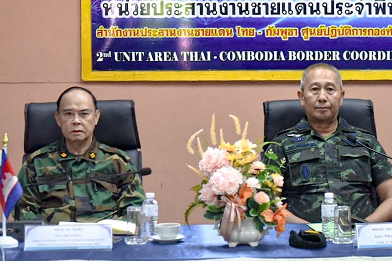 This May 29, 2025, photo released by the Royal Thai Army shows the Commander-in-chief of the Royal Thai Army (RTA) General Pana Klaewplodthuk, right, and the Commander of the Royal Cambodian Army General Mao Sophan at the Chong Chom border crossing in Thailand's Surin province.