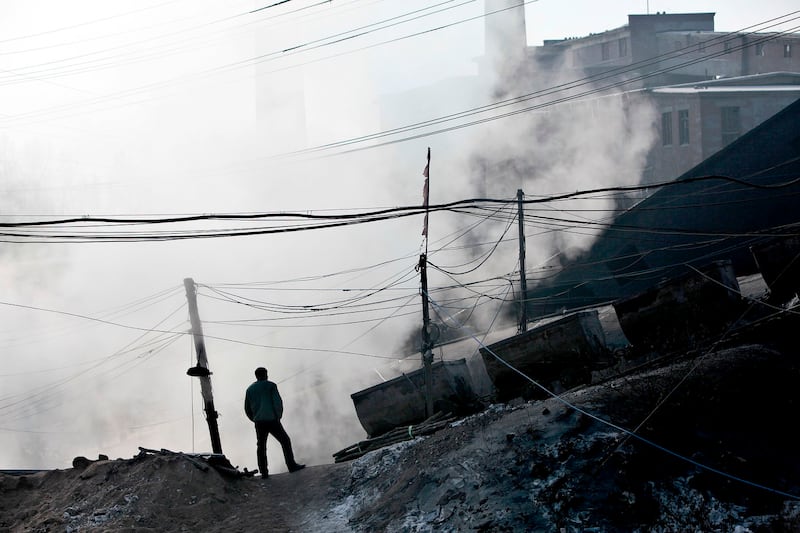 A mineworker stands near a gas explosion site at the Xinxing Coal Mine in Hegang, Heilongjiang Province, Nov. 23, 2009. Credit: Reuters
