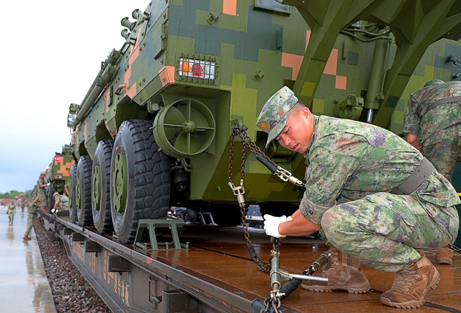 Soldiers unload military vehicles at Phonhong Railway Station in Laos’ Vientiane province on July 2, 2024. (Yi Ding/Xinhua via Getty Images)
