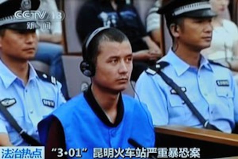 This Chinese TV screen grab shows Turgun Tohtunyaz at a court trial in Kunming, Sept. 12, 2014.