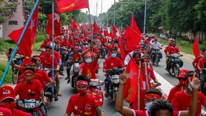 Supporters of the National League for Democracy party ride in a campaign rally motorcade through the town of Wundwin in central Myanmar's Mandalay region, Sept. 19, 2020.