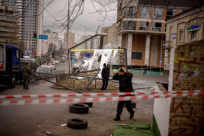 Police officers inspect the location of an apparent Russian strike in Kyiv, Ukraine, on Feb. 24, 2022. (Associated Press)