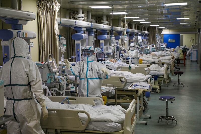 Medical workers attend to COVID-19 patients in the intensive care unit of a hospital in Wuhan, China, on Feb. 6, 2020.