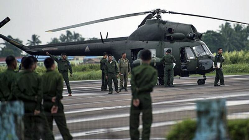Myanmar soldiers stand guard as air force helicopters arrive at the airport in Sittwe, capital of western Myanmar's Rakhine state, Oct. 13, 2016.