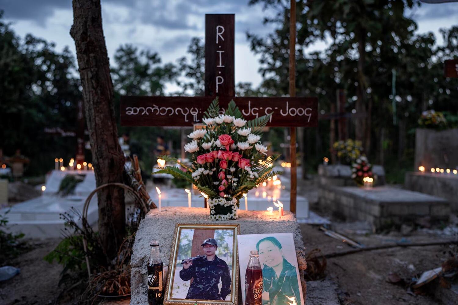 Candles and flowers adorn a grave in a cemetery for KNDF soldiers who died fighting junta forces, in Demoso, Kayah state, Myanmar, Nov. 2, 2024.