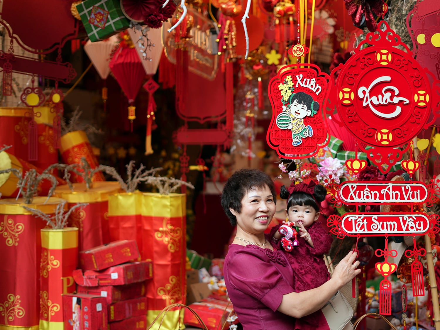 A woman holds her granddaughter as they visit the Lunar New Year 