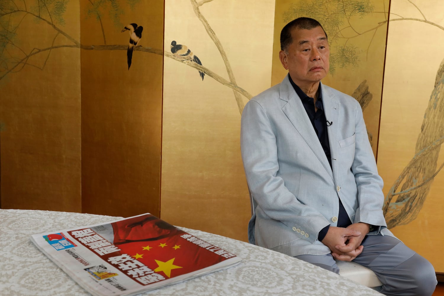 Hong Kong media tycoon Jimmy Lai and a copy of Apple Daily's July 1, 2020, edition during an interview in Hong Kong, July 1, 2020.