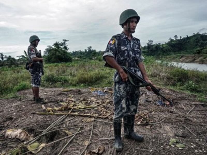 Myanmar border police stand guard in Tinmay village, Buthidaung township, in the northern part of western Myanmar's Rakhine state, July 14, 2017. 