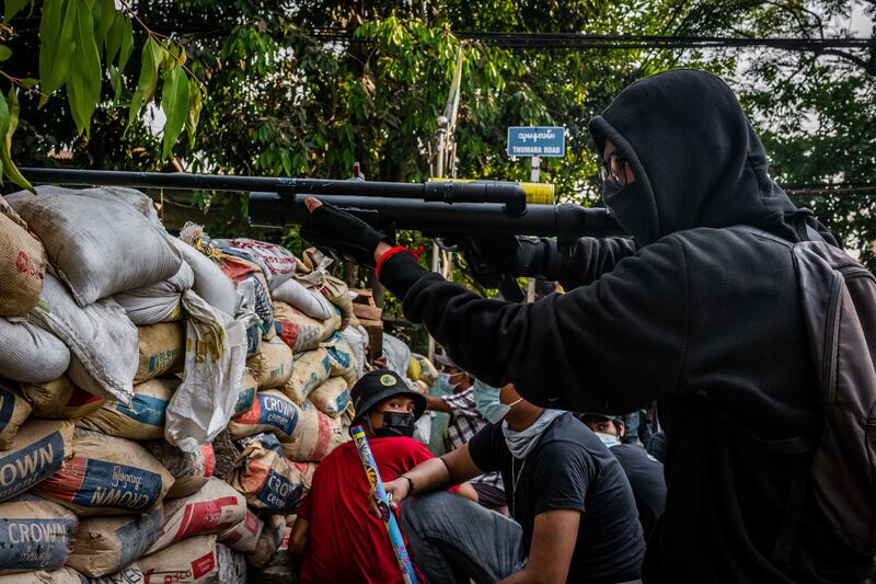 An anti-coup protester aims an improvised weapon on March 28, 2021 in Yangon, Myanmar.