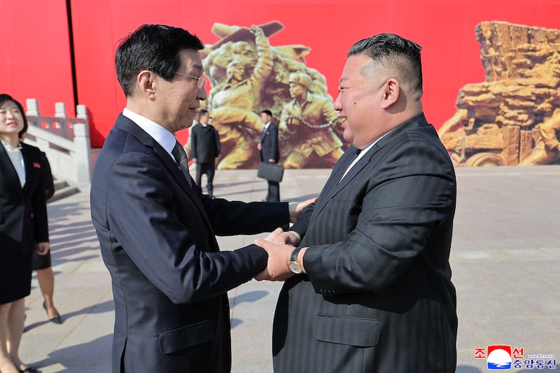 North Korean leader Kim Jong Un, right, shaking hands with Wang Huning, the fourth highest ranked member of the Chinese Communist Party in Dandong, China, Oct. 24, 2026.