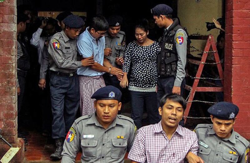 Detained Myanmar journalists Kyaw Soe Oo (front-C) and Wa Lone (back-2nd from R) are escorted by police from a courthouse following a hearing in Yangon, Myanmar, July 9, 2018.