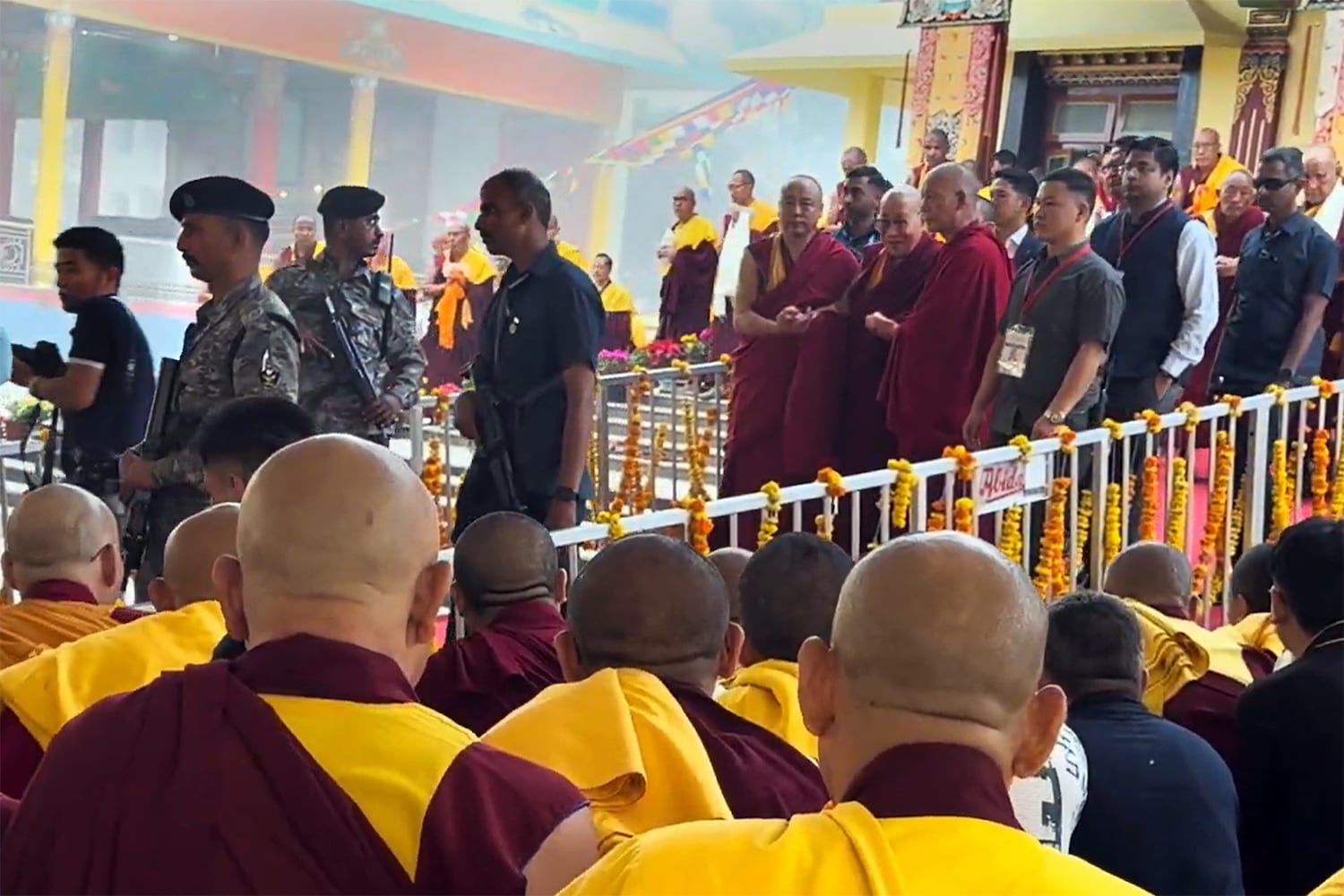 The  Dalai Lama (center) is guarded by the members of the Central Reserve Police Force in Hunsur, Karmataka state, India, Feb. 18, 2025.