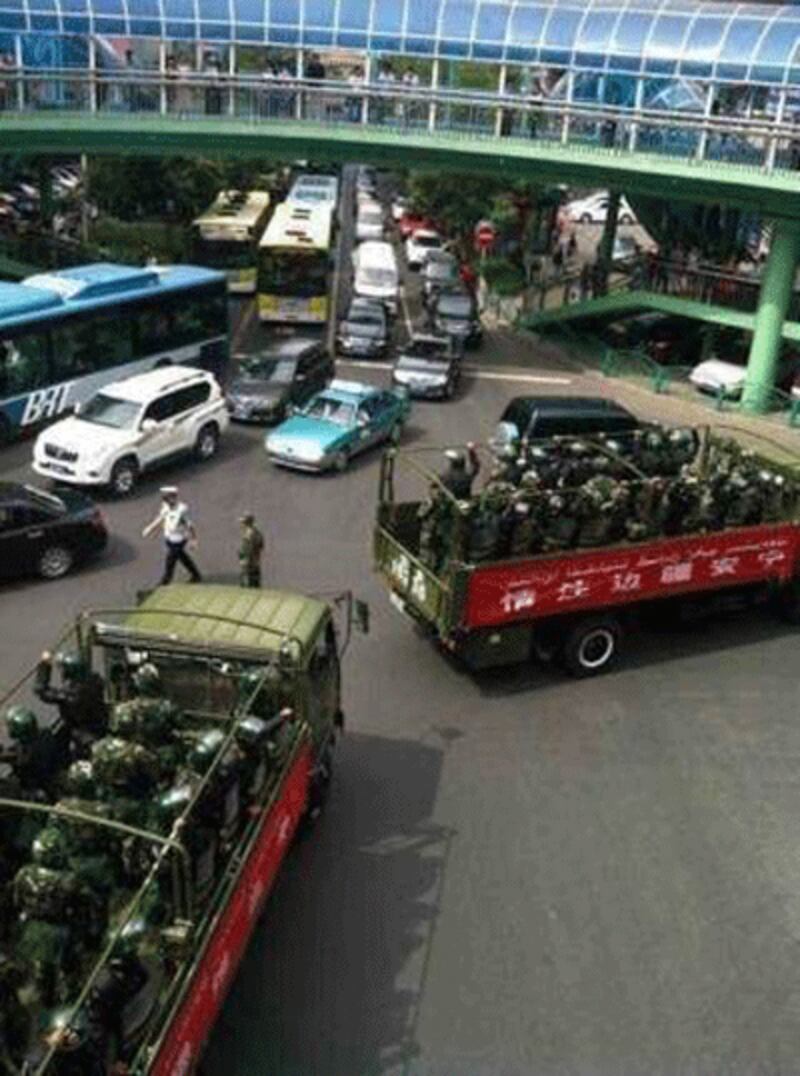 Chinese military vehicles carrying People's Armed Police entering Urumqi, June 29, 2013.