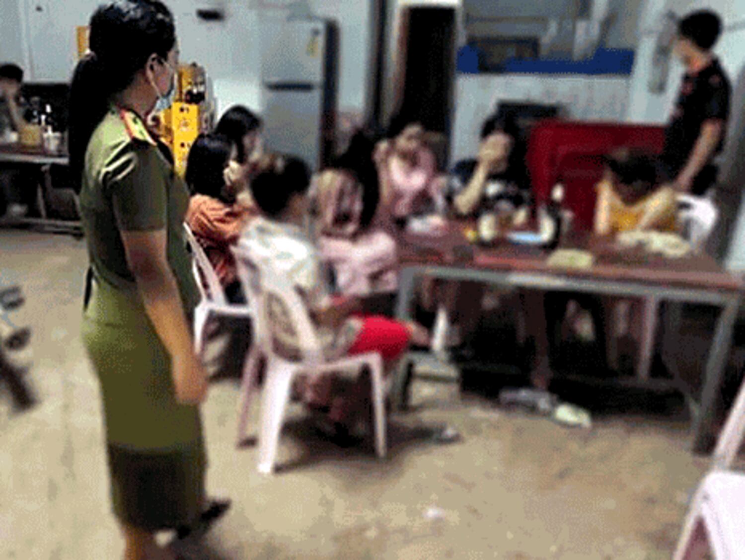 Police raid a restaurant suspected of providing sex services to customers in Vientiane, capital of Laos, Jan. 2022.